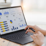 Professional analyzing financial data graphs, charts on laptop display at a modern workspace. Financial analysis or business evaluation concept; Shutterstock ID 2457599913; purchase_order: ASUS-Commercial-ExpertBook B5 Refreshed (B5405CAA / B5605CAA) Scenario photos; job: ASUS-Commercial-ExpertBook B5 Refreshed (B5405CAA / B5605CAA) Scenario photos; client: ASUS; other: ASUS-Commercial-ExpertBook B5 Refreshed (B5405CAA / B5605CAA) Scenario photos